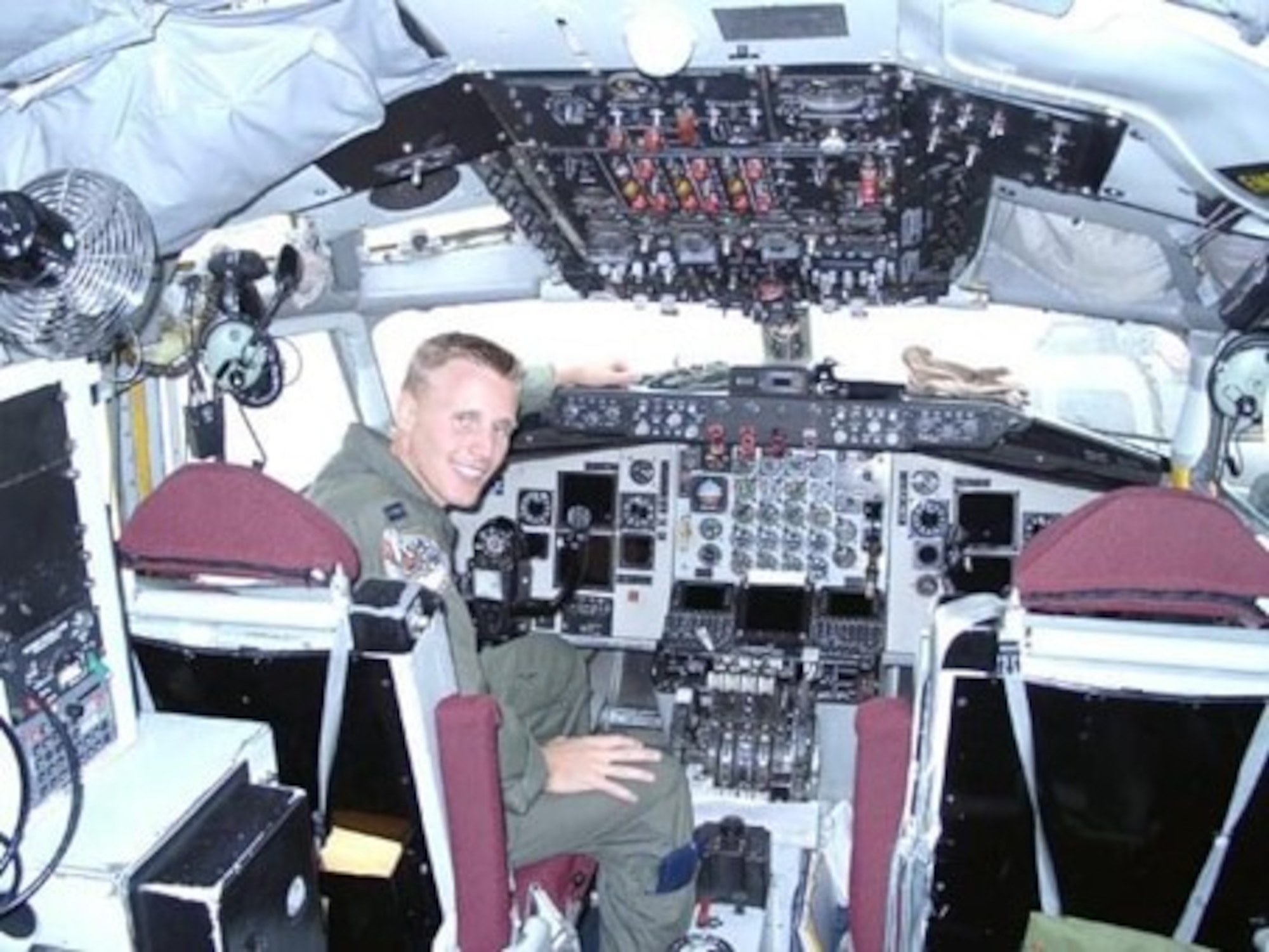 Then Capt. Nicolas Henschel sits in the cockpit of a 108th Air Refueling Squadron KC-135 Stratotanker.