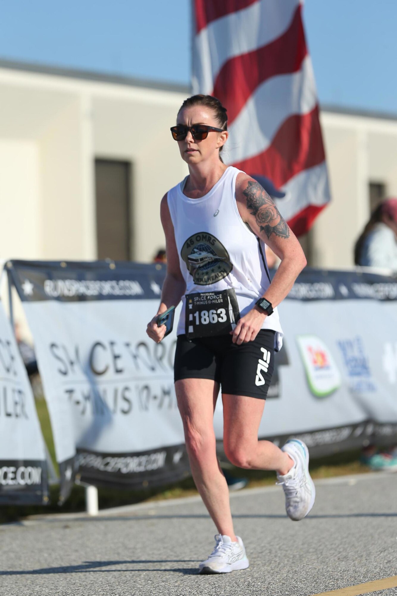 A female runner finishes the the inaugural United States Space Force T-Minus 10-Miler at Cape Canaveral Space Force Station, Fla.