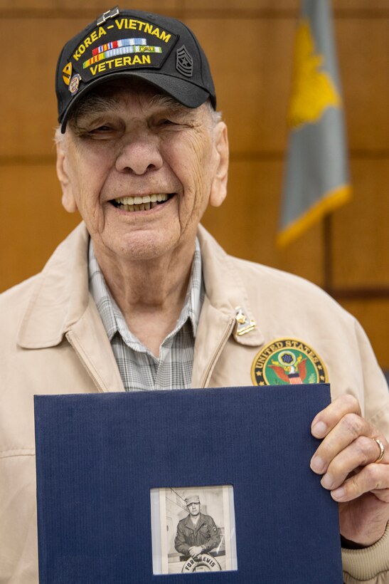 Retired U.S. Army Sgt. Maj. Bruce Fonda poses with a photo album he brought to the reactivation of his old unit, the 45th Finance Center, during a ceremony at the Maj. Gen. Emmett J. Bean Federal Center in Indianapolis Nov. 6, 2023. Fonda, a Korean War and Vietnam War veteran, served from 1950-1976 and served in the 45th Finance Section in Pirmasens, Germany, from 1965-1967. (U.S. Army photo by Mark R. W. Orders-Woempner)