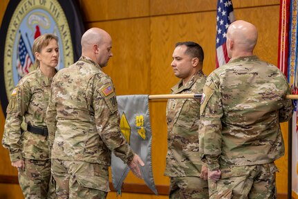 Lt. Col. Jason Shick, 45th Finance Center acting director, unfurls a 45th FC guidon as Brig. Gen. Paige M. Jennings, U.S. Army Financial Management Command commanding general; Master Sgt. Daniel Reyes Baerga, 45th FC acting senior enlisted advisor; and Sgt. 1st Class Jerrod Newman, USAFMCOM senior financial management systems instructor, look on during a ceremony reactivating the 45th FC at the Maj. Gen. Emmett J. Bean Federal Center in Indianapolis Nov. 6, 2023. As USAFMCOM’s operational arm and early deployer, the 45th FC is required to be ready to deploy at a moment’s notice to conduct theater preparation operations; provide timely procurement and theater disbursing support through the establishment of central funding operations; and enable joint, interagency, intergovernmental and multinational operations. (U.S. Army photo by Staff Sgt. Joshua Syberg)