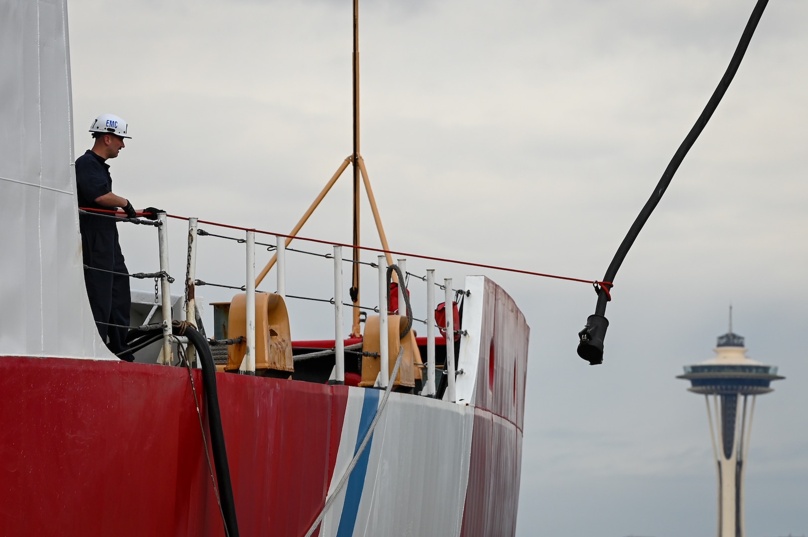 An electrical shore-tie is disconnected from U.S. Coast Guard Cutter Polar Star (WAGB 10) as crew members make final preparations to get the vessel underway from Base Seattle on Nov. 15, 2023. The Polar Star is a 399-foot heavy icebreaker that was commissioned in 1976. (U.S. Coast Guard photo by Petty Officer Steve Strohmaier)