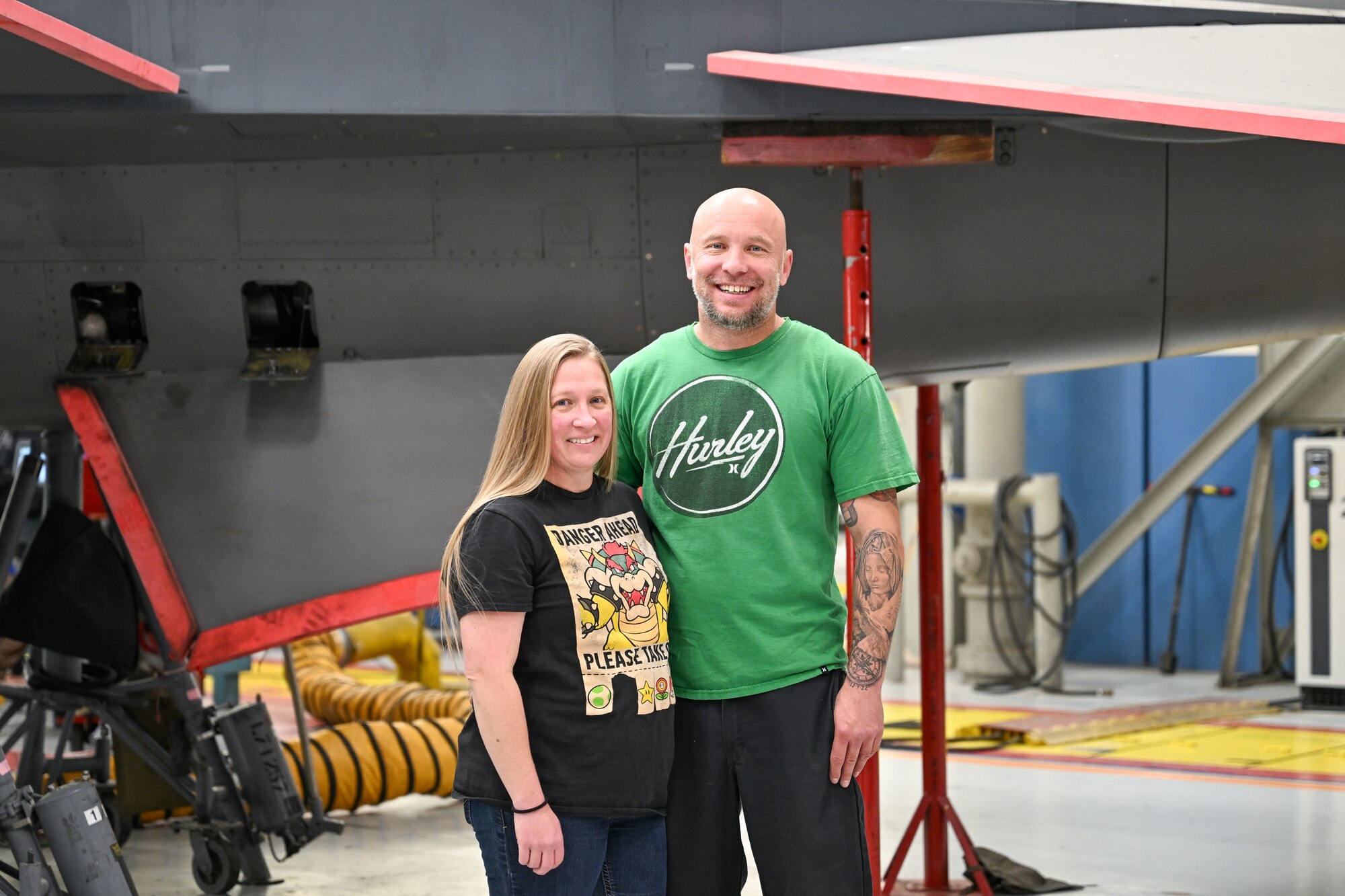 Brian and Brandy Stewart, 573rd Aircraft Maintenance Squadron, pose in front of an F-16 Fighting Falcon in depot maintenance at Hill Air Force Base, Utah. The aircraft technicians are this month's Ogden Air Logistics Complex featured employees. (U.S. Air Force photo by Cynthia Griggs)