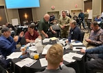 Multiple agencies take part in a group discussion during the Evergreen Spill Tabletop Exercise in Airway Heights, Wash., Nov. 8, 2023. This exercise tested the response of the Washington National Guard, Tribal emergency managers and state and federal agencies to a hypothetical hazardous waste spill on the Colville Indian Reservation.