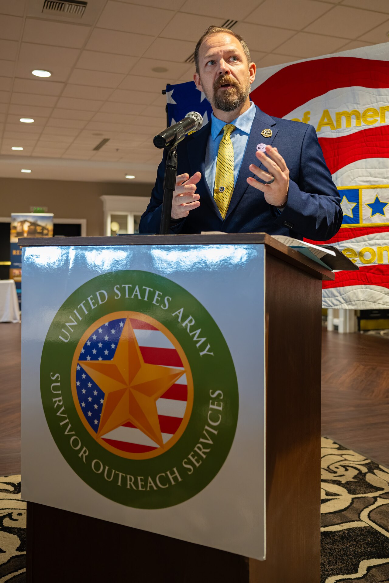Chad Graham, president and CEO of the Woody Williams Foundation, speaks to audience members on Millionaire’s Row at Churchill Downs Racetrack in Louisville, Ky., Nov. 5, 2023, as part of Survivor’s Day at the Races, an annual event to honor family members who've lost loved ones in military service to the United States. The foundation actively supports Gold Star Family outreach programs across the nation in remembrance of fallen service members. (U.S. Air National Guard photo bay Dale Greer)