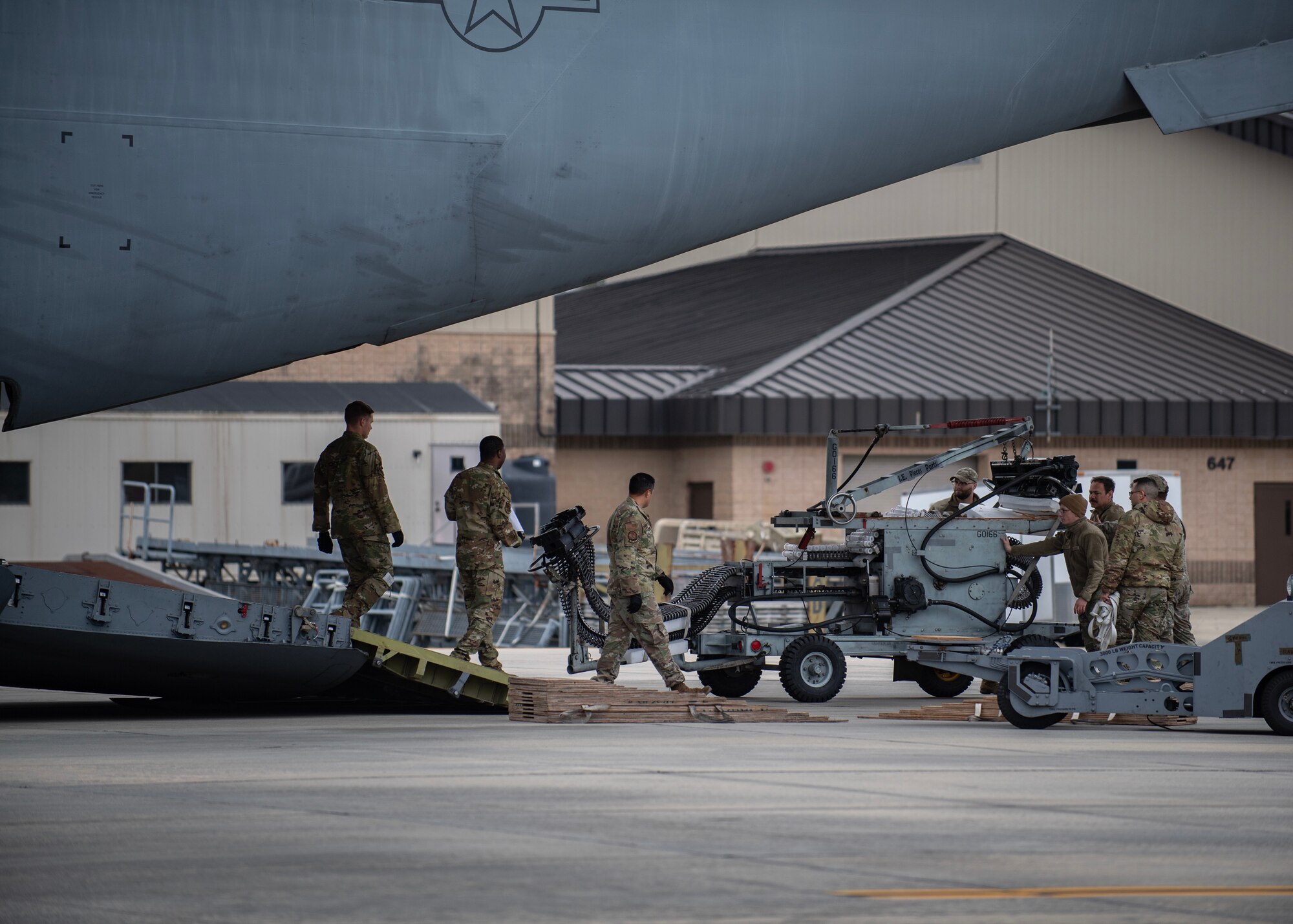 U.S. Air Force Airmen assigned to the 23rd Wing move an ammunition loading adapter onto a C-17 Globemaster III assigned to the 437th Airlift Wing before transporting cargo and Airmen to a simulated continency location at Avon Park Air Force Range, Florida, as part of Mosaic Tiger 24-1, Nov. 13, 2023. The ALA is commonly known as the “Dragon,” because when the belt feeder is extended, it takes the familiar shape as it loads 30mm bullets into the GAU-8 Avenger autocannon. (U.S. Air Force photo by Master Sgt. Daryl Knee)