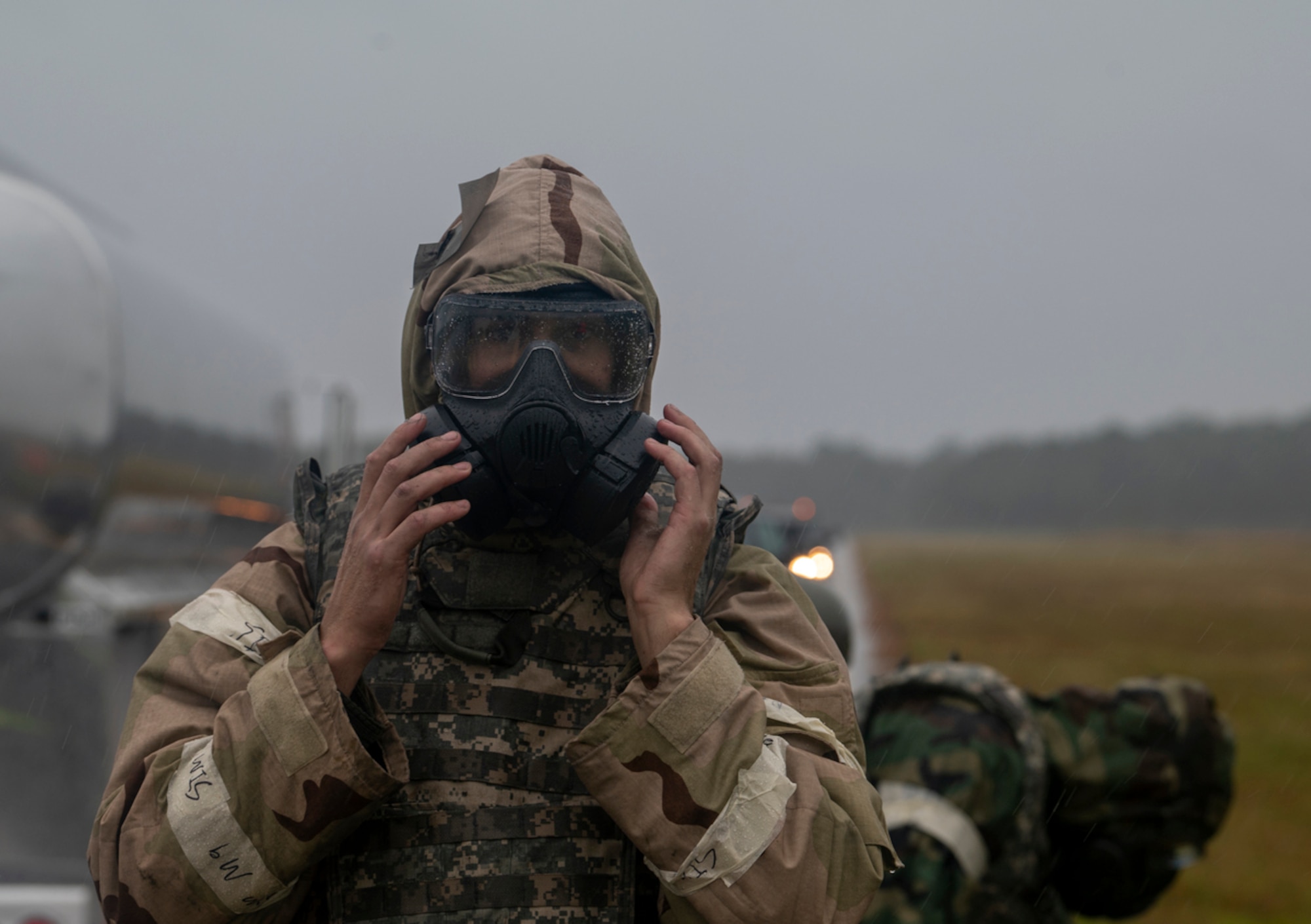 U.S. Air Force Staff Sgt. David Walker, 74th Fighter Generation Squadron weapons load team chief, puts on a gas mask at Avon Park Air Force Range, Florida, Nov. 15, 2023. During an ICT, experienced crews can reload munitions and refuel a jet in under half an hour. (U.S. Air Force photo by Airman 1st Class Leonid Soubbotine)