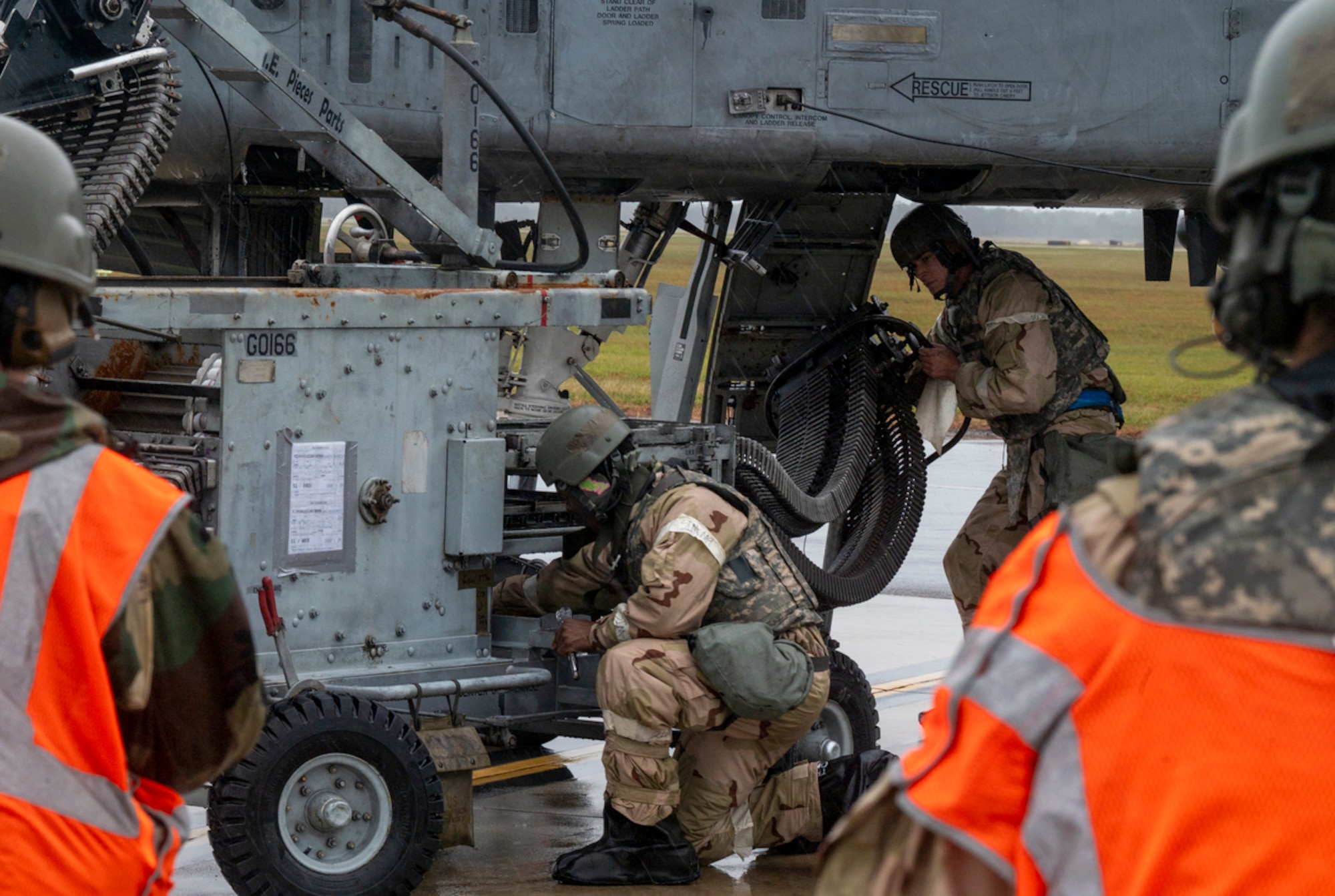 U.S. Air Force Senior Airman Howell Marian (left), 74th Fighter Generation Squadron weapon load crewmember, and U.S. Air Force Staff Sgt. David Walker (center), 74th Fighter Generation Squadron weapon load team chief, set up the A-10C Thunderbolt II to receive munition at Avon Park Air Force Range, Florida, Nov. 15, 2023. The weapons Airmen loaded 1150 rounds in the A-10’s 30 mm GAU-8/A Avenger Gatling gun.  (U.S. Air Force photo by Airman 1st Class Leonid Soubbotine)