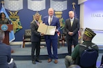 Paul Luehr, Naval Surface Warfare Center, Carderock Division's Deputy Department Head for the Signatures Department, receives the Secretary of Defense Disability Award at the Pentagon in Arlington, Virginia, on Oct. 26, 2023.