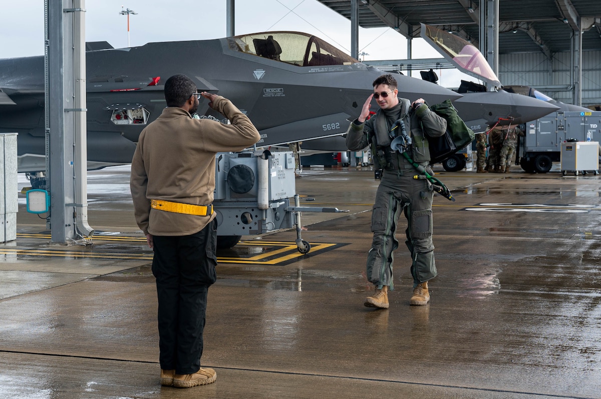U.S. Air Force Capt. Patrick Pearce, 493rd Fighter Squadron pilot, greets Airman 1st Class Micheal Ademoye, 493rd Fighter Generation Squadron crew chief, during exercise Atlantic Trident 2023 at RAF Lakenheath