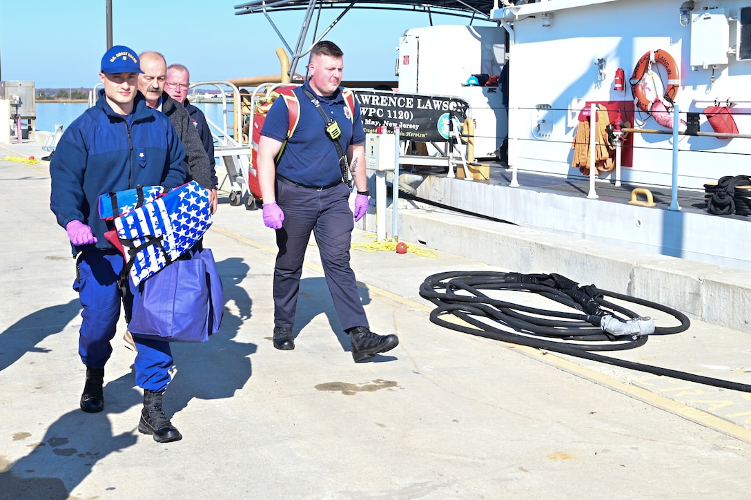 U.S. Coast Guard personnel receive an overdue mariner who was rescued at sea by the CGC Lawrence Lawson (WPC 1120) Nov. 16, 2023, in Cape May, NJ. The mariner was reported overdue by family after regular communication was lost