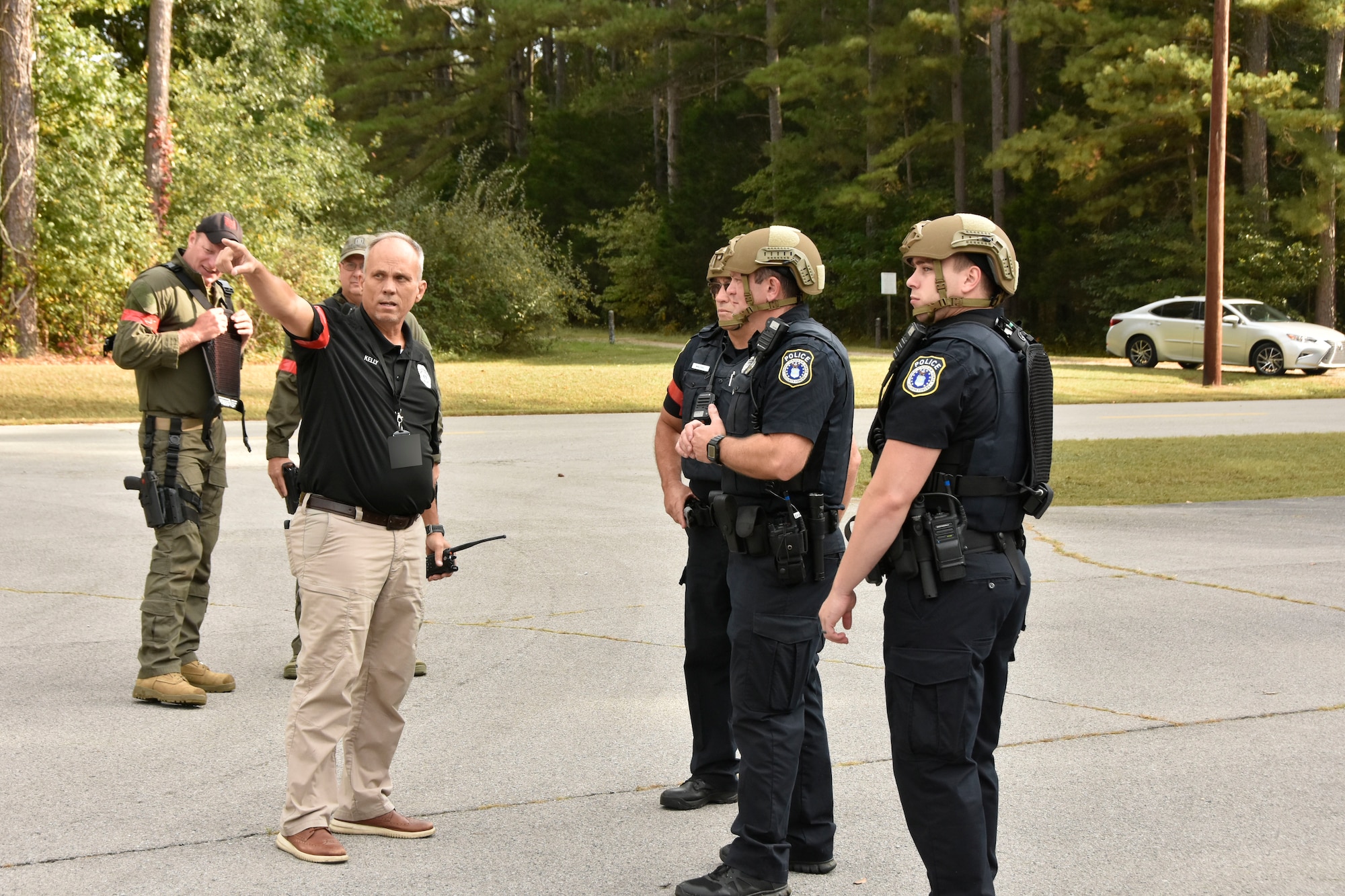 Arnold Air Force Base Security Forces Chief Ray Kelly shares observations with Arnold AFB Security Forces personnel following an active shooter exercise conducted Sept. 28, 2023, at Arnold AFB, Tenn. (U.S. Air Force photo by Bradley Hicks) (This image has been altered by obscuring a badge for security purposes)