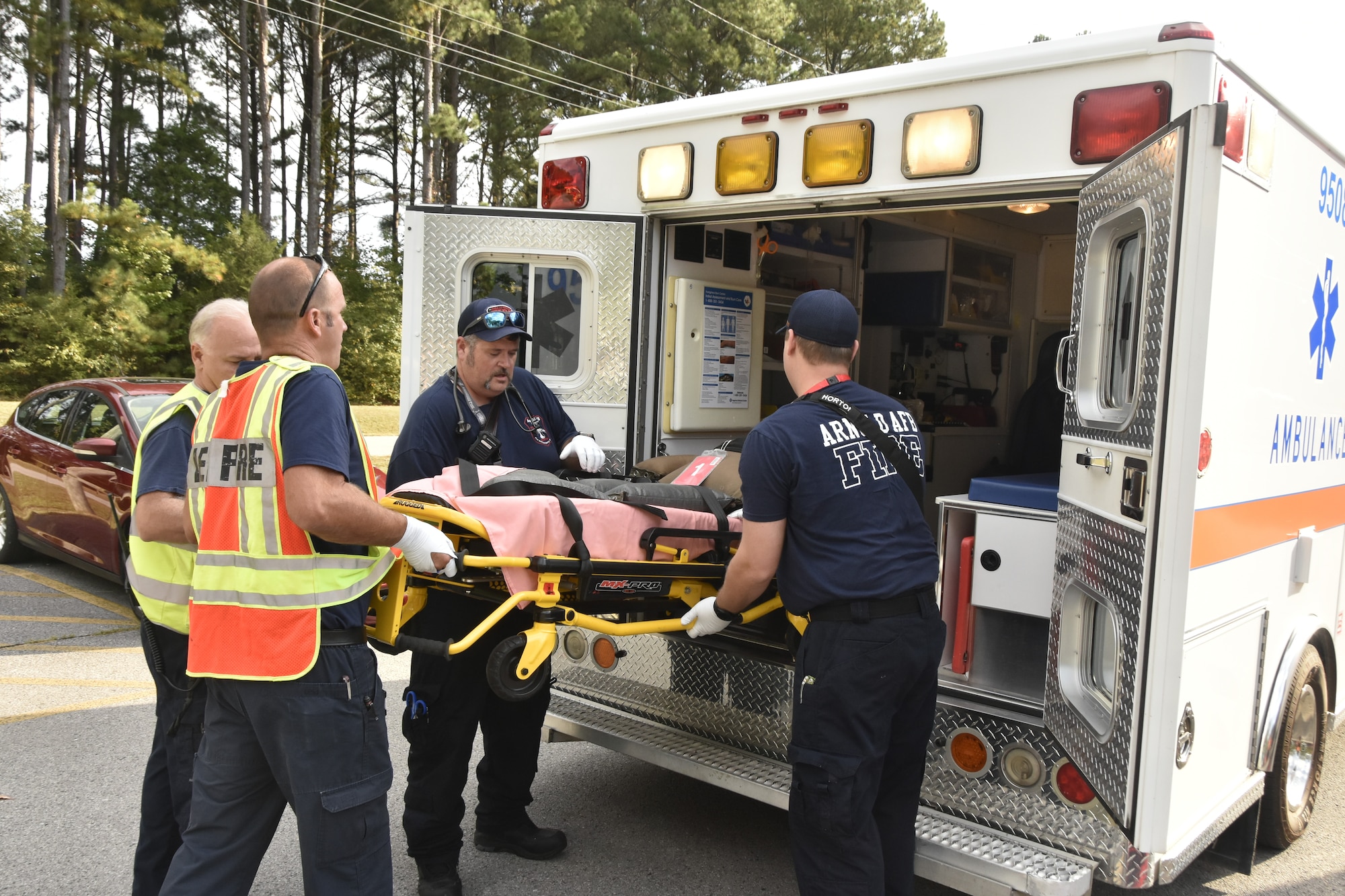 A simulated patient is loaded for transport by Arnold Air Force Base Fire and Emergency Services EMS during an active shooter exercise conducted Sept. 28, 2023, at Arnold AFB, Tenn. (U.S. Air Force photo by Bradley Hicks)