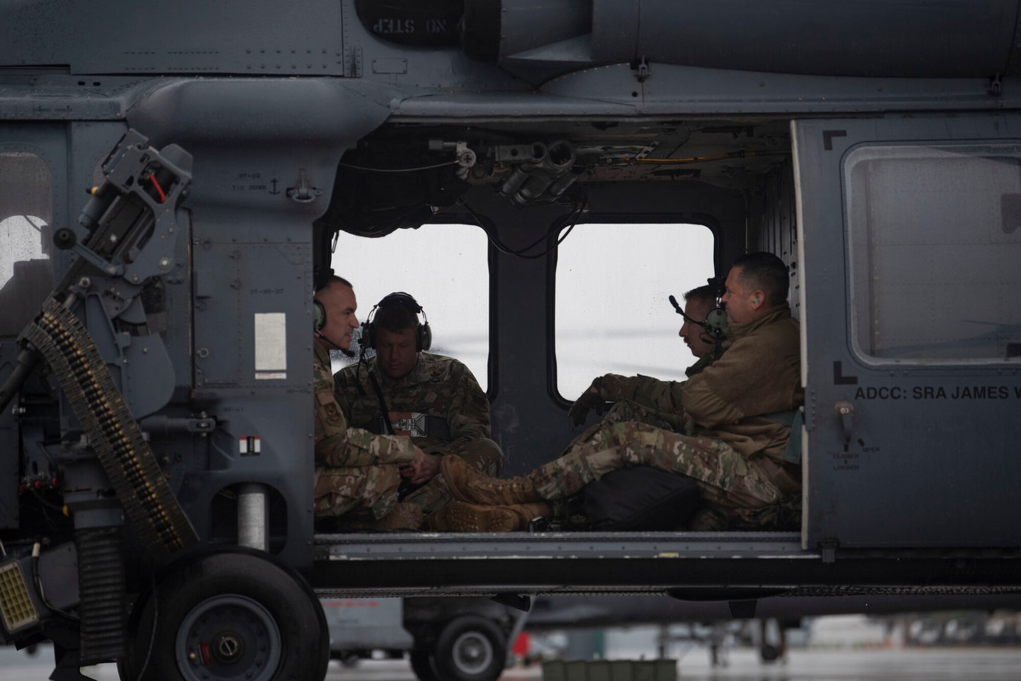 Members of 23rd Wing leadership await take-off on-board an HH-60W Jolly Green II helicopter piloted by U.S. Air Force Col. Paul Sheets, 23rd Wing commander during Mosaic Tiger 24-1 at Moody Air Force Base, Georgia, Nov. 16, 2023. During exercise Mosaic Tiger 24-1, 23rd Wing leadership flew to a simulated contingency location at Avon Park Air Force Range, Florida to visit exercise participants and to experience the conditions of the simulated contingency location. (U.S. Air Force photo by Staff Sgt. Thomas Johns)