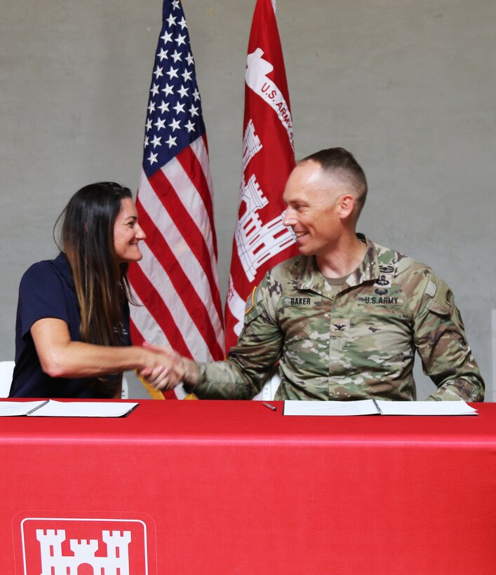 Col. Andrew Baker, U.S. Army Corps of Engineers LA District commander, right, and Stacy Gorin, executive director of the Southern California Mountains Foundation, left, celebrate after signing a commemorative document acknowledging a Cooperative Partnership Agreement – the first one of its kind in this region – between the U.S. Army Corps of Engineers Los Angeles District and the Southern California Mountains Foundation Oct. 17 in Hesperia, California.
