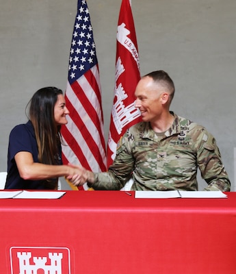 Col. Andrew Baker, U.S. Army Corps of Engineers LA District commander, right, and Stacy Gorin, executive director of the Southern California Mountains Foundation, left, celebrate after signing a commemorative document acknowledging a Cooperative Partnership Agreement – the first one of its kind in this region – between the U.S. Army Corps of Engineers Los Angeles District and the Southern California Mountains Foundation Oct. 17 in Hesperia, California.