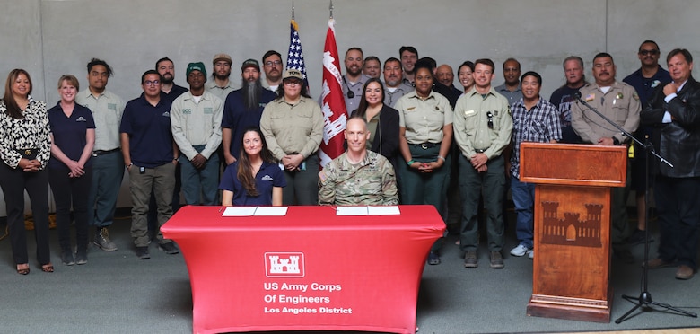 Representatives with the U.S. Army Corps of Engineers LA District, U.S. Representative Jay Obernolte’s office; San Bernardino National Forest; U.S. Bureau of Land Management; San Bernardino County Sheriff’s Department; Urban Conservation Corps of the Inland Empire, under the umbrella of the Southern California Mountains Foundation; and Hesperia Recreation and Park District pose for a picture after signing a commemorative document acknowledging a Cooperative Partnership Agreement between the LA District and the Southern California Mountains Foundation Oct. 17 in Hesperia, California.