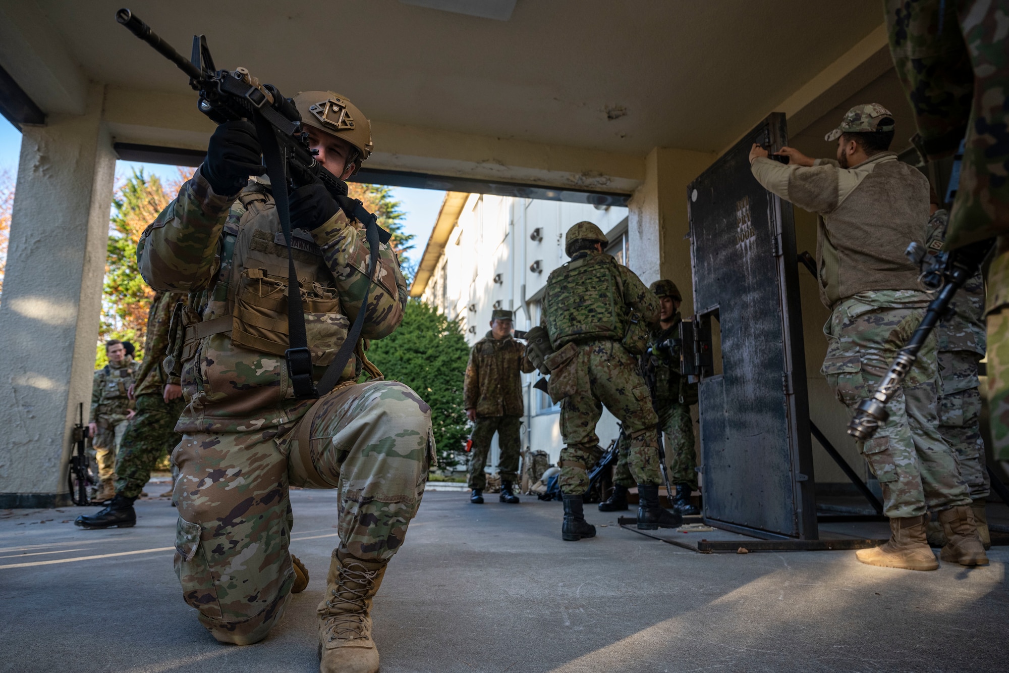 A service member provides cover during a training.
