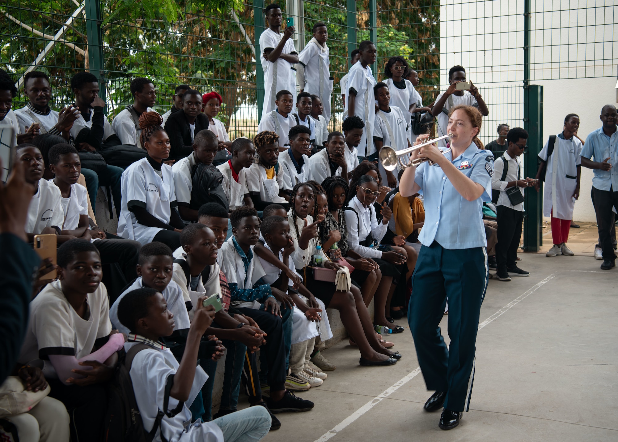U.S. Air Force Senior Airman Clare Hogan, from the USAFE-AFAFRICA Band, plays the trumpet during a performance for students at the Polytechnic Institute of Art in Kilamba, Angola