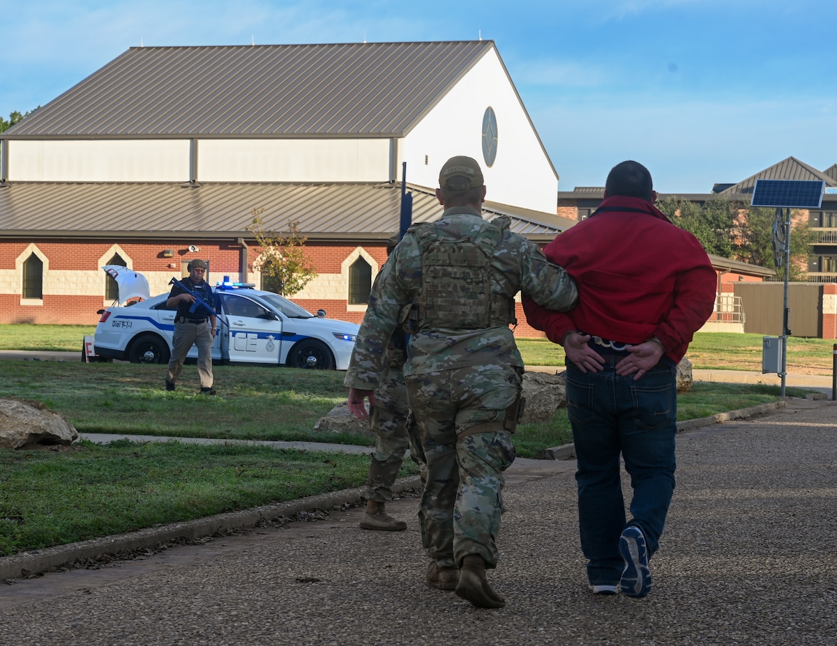 U.S. Air Force Senior Airman Brandon Anderson, 17th Security Forces Squadron Defender, detains a simulated perpetrator during an exercise at Goodfellow Air Force Base, Texas, Nov. 16, 2023. The drill was conducted to test and enhance the response capabilities of the base in the event of a real-world threat. (U.S. Air Force photo by Airman 1st Class Zach Heimbuch)