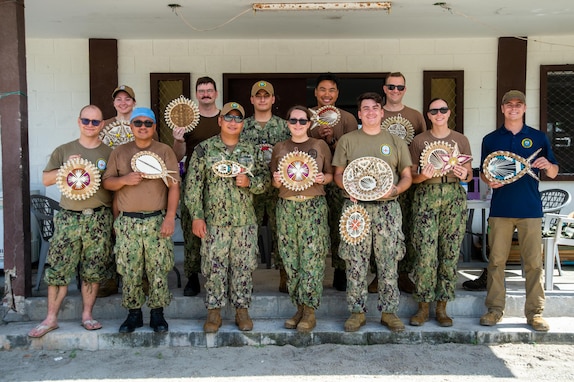 U.S. Navy Sailors pose for a photo with gifts received after completion of medical and dental clinics in Aur Atoll, Republic of the Marshall Islands, during Pacific Partnership 2024-1 Nov. 10, 2023. Now in its 19th iteration, Pacific Partnership is the largest annual multinational humanitarian assistance and disaster relief preparedness mission conducted in the Indo-Pacific. (U.S. Navy photo by Mass Communication Specialist 2nd Class Jacob Woitzel)