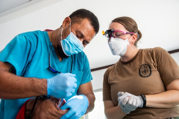 U.S. Navy Lt. Cmdr. Amie Heim, from Buffalo, New York, right, and Jofiliti Tuiloma, a Marshallese dentist, perform a tooth extraction on a Marshallese patient in Aur Atoll, Republic of the Marshall Islands, during Pacific Partnership 2024-1 Nov. 10, 2023. Now in its 19th iteration, Pacific Partnership is the largest annual multinational humanitarian assistance and disaster relief preparedness mission conducted in the Indo-Pacific. (U.S. Navy photo by Mass Communication Specialist 2nd Class Jacob Woitzel)