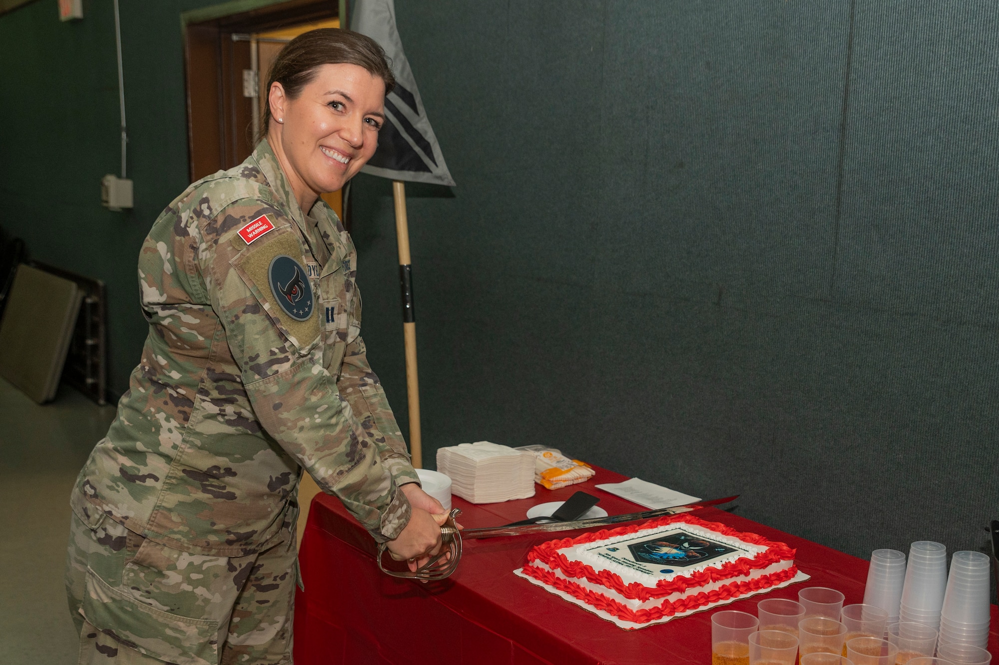 U.S. Space Force Capt. April Dybal, 5th Space Warning Squadron Detachment 3 commander, cuts a cake during her unit’s activation ceremony at Osan Air Base, Republic of Korea, Oct. 27, 2023.