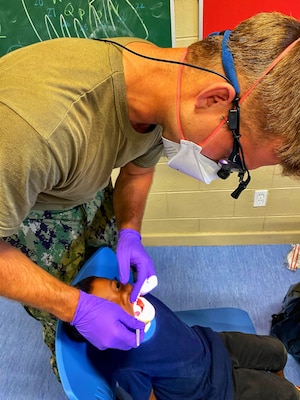 U.S. Navy Lt. Theodore Slagle, dentist, performs a routine dental exam on a young Ebeye student as part of Pacific Partnership, November 3. The dentists saw about 800 residents over the two-day event on Ebeye.