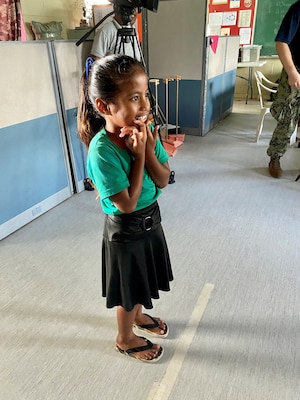 A young Ebeye Elementary School student recites the letters of the eye chart during her initial vision screening before receiving her first pair of glasses.