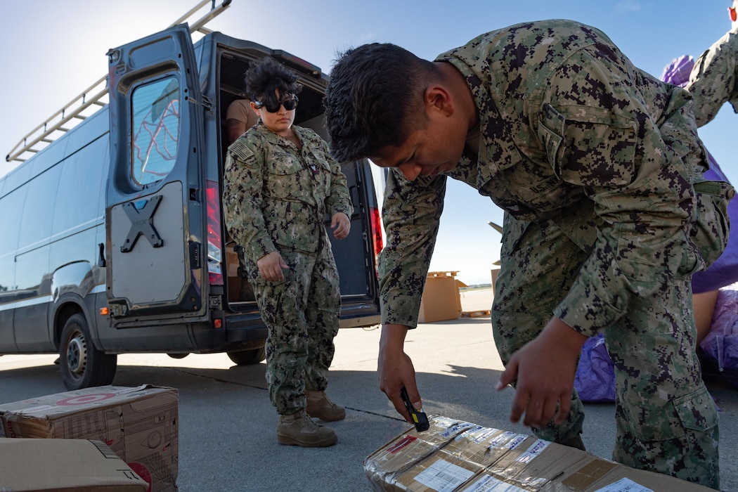 Logistics Specialist 2nd Class Madai Lopez-Esqueda and Retail Services Specialist 2nd Class Miguel Alonso Rodriguez, both assigned to Naval Supply Systems Command Fleet Logistics Center (NAVSUP FLC) Sigonella, Site Souda Bay, sort mail and packages bound for Naval Support Activity Souda Bay and forward-deployed ships operating in the region on Nov. 15, 2023.