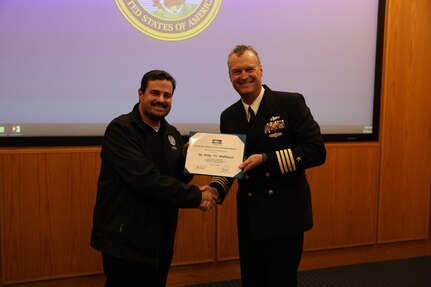 Naval Surface Warfare Center, Philadelphia Division (NSWCPD) Commanding Officer (CO) Capt. Joseph Darcy (right) presents Federal Emergency Management Agency (FEMA) Region Three Regional Disability Integration Specialist Philip “PJ” Mattiacci (left) with a Certificate of Appreciation for providing the keynote address for NSWCPD’s National Disability Employment Awareness Month Observance on Oct. 19, 2023. (U.S. Navy photo by Phillip Scaringi/Released)