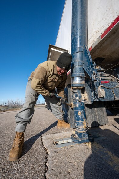 U.S. Air Force Airmen 1st Class Jonas Castillo, 91st Missile Maintenance Squadron mechanic, tears off the transporter erector from the missile site pad at Minot Air Force Base, North Dakota, Nov. 16, 2023. The Transporter Erector is used to lower the Minute Man III, into one of many missile silos around Minot AFB’s area of responsibility. (U.S. Air Force photo by Airman 1st Class Alexander Nottingham)