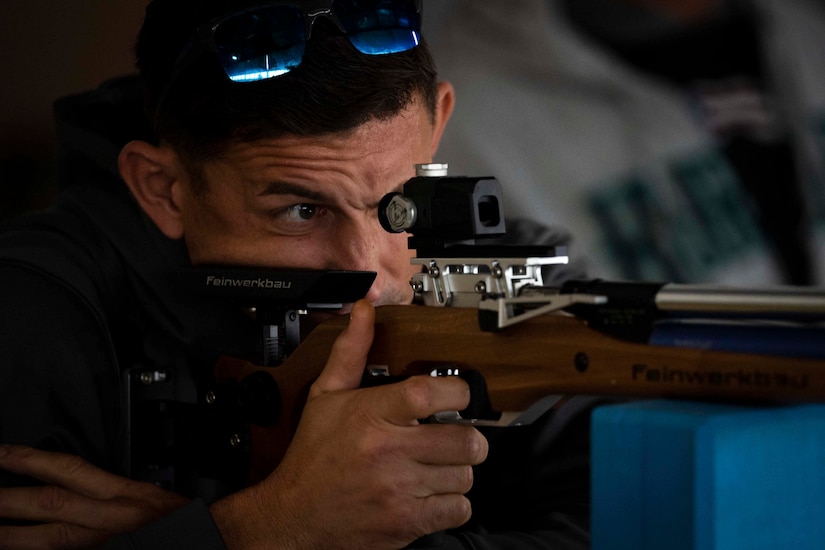 A close-up of a Marine looking through the scope of a weapon.