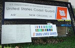 U.S. Coast Guard Air Station New Orleans sign leaning against a building after hurricane Katrina made landfall in August 2005.