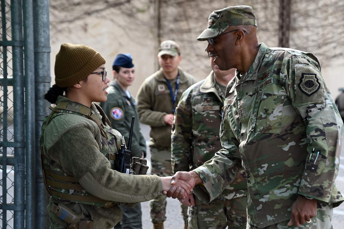 Chairman of the Joint Chiefs of Staff Gen. CQ Brown, Jr. shakes hands with Airman 1st Class Francine Ann Bautista, 51st Security Forces Squadron, during a visit to Osan Air Base, Republic of Korea, Nov. 11, 2023.
