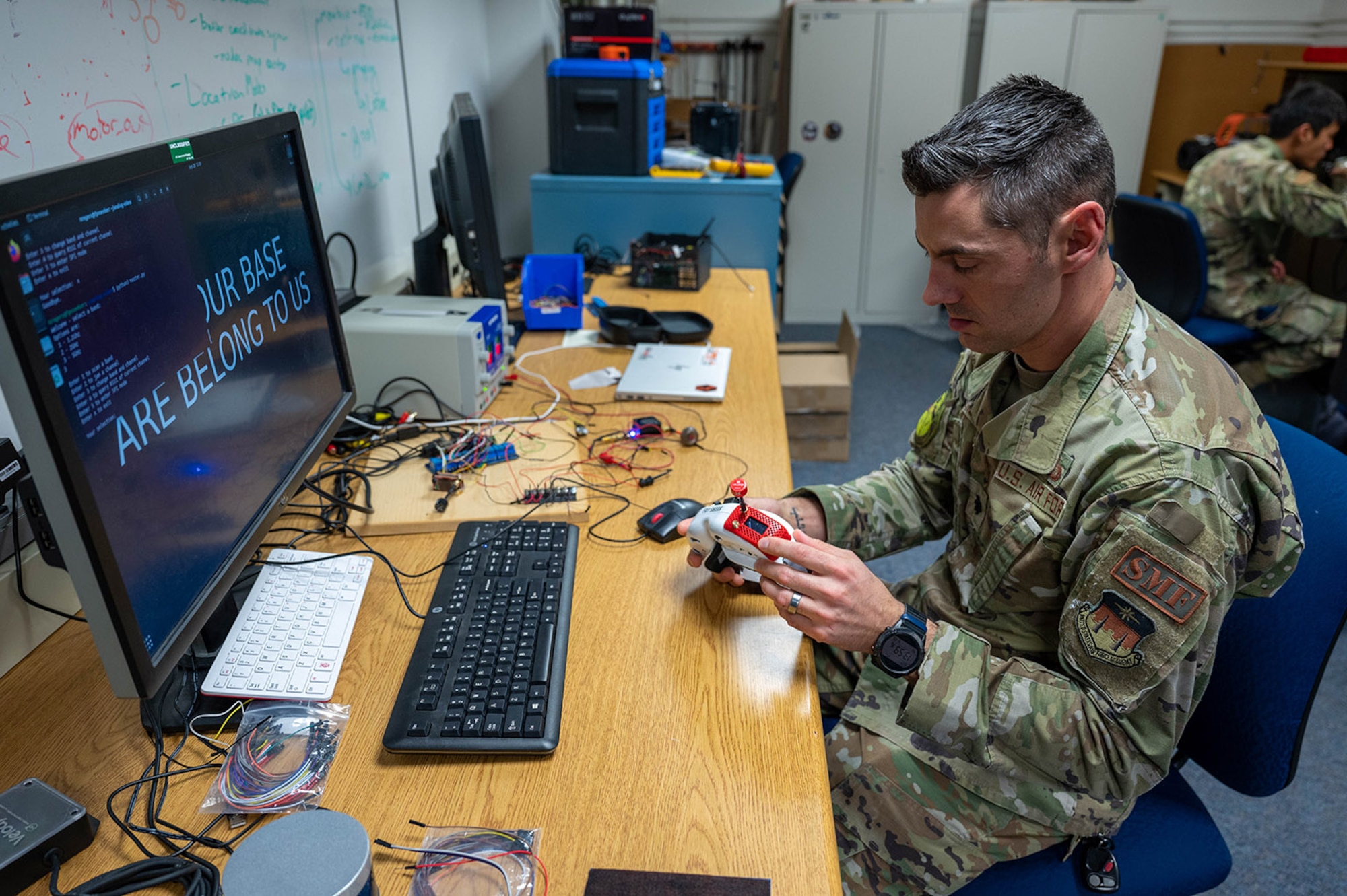 Lt. Col. Neil Rogers verifies the proper wiring and operation of a U.S. Air Force Academy cadet project