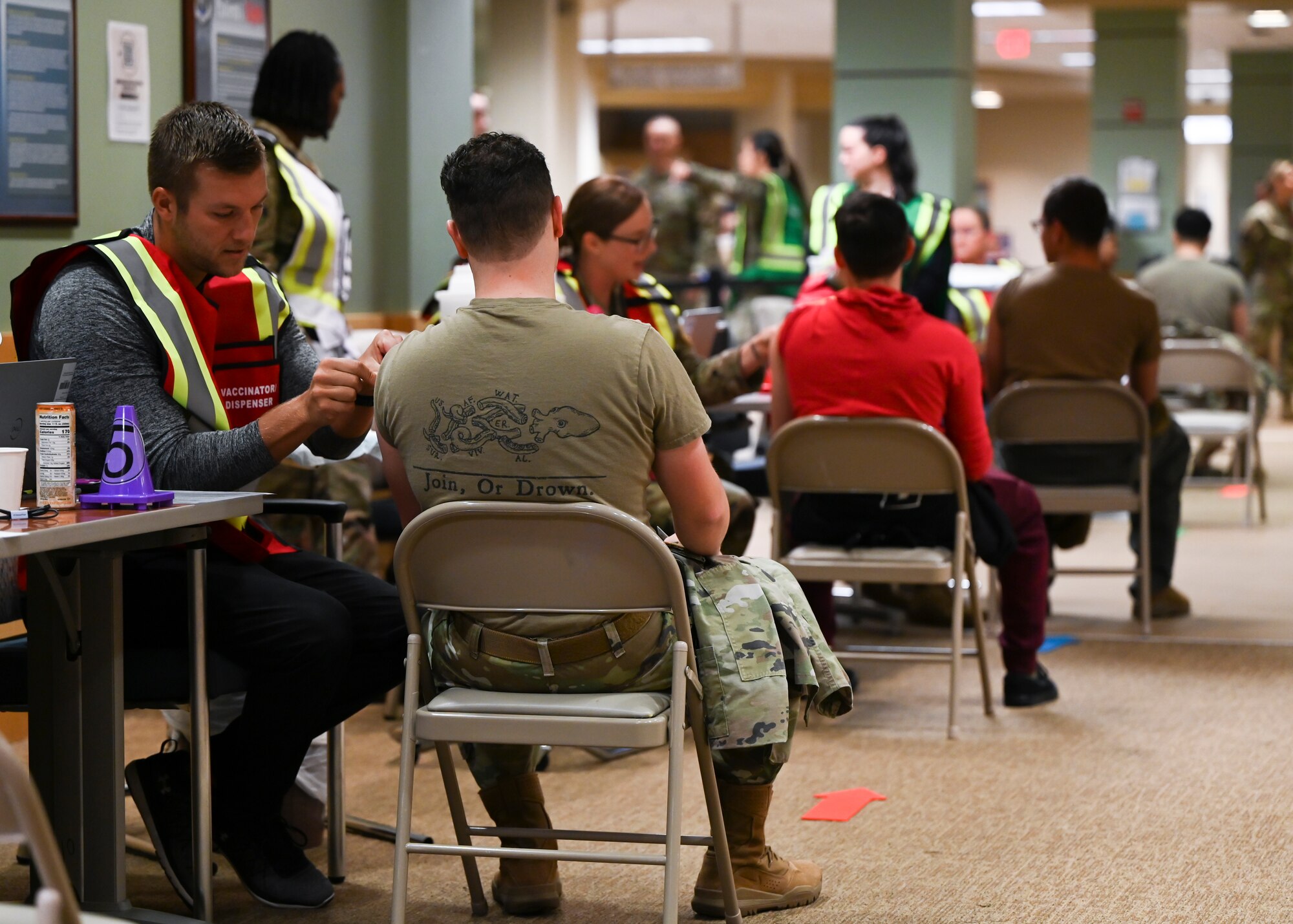Numerous people receive their vaccine by medical staff inside the hospital.