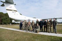 U.S. Air Force and Navy service members pose for a photo with Ukrainian defenders in front of a static aircraft