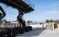 Aerial Port Squadron Airmen demonstrate a cargo K-loader capabilities while on the flight line