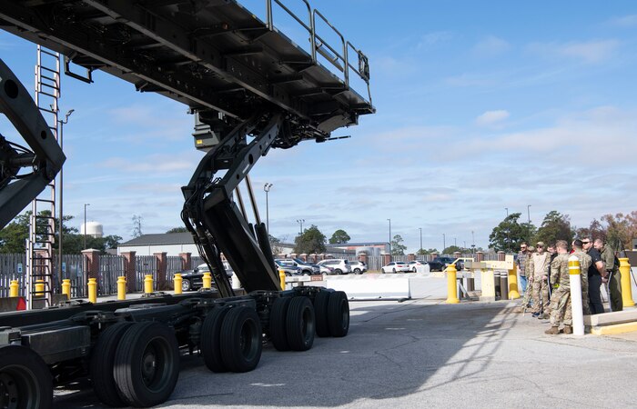 Aerial Port Squadron Airmen demonstrate a cargo K-loader capabilities while on the flight line