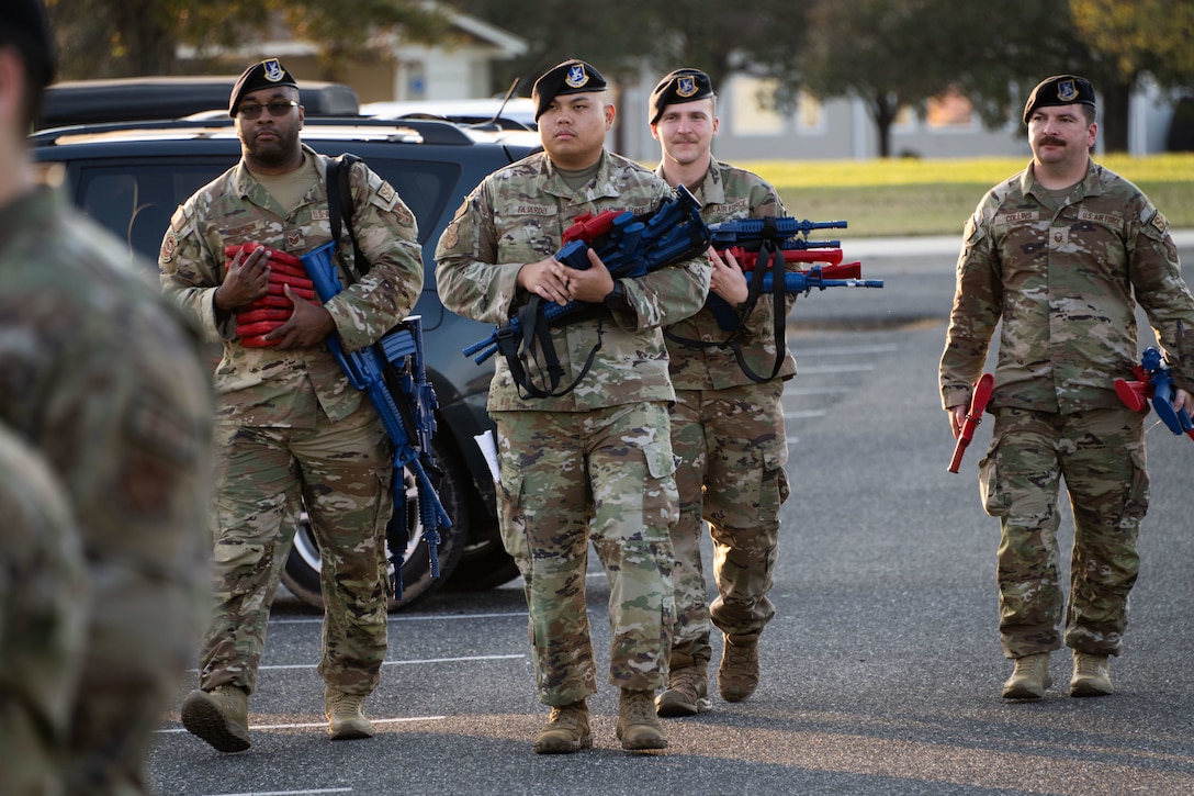 From left, U.S. Air Force Tech. Sgt. Raymond Simpson, Staff Sgt. Michael Fajardo, Staff Sgt. Benjamin Wentworth and Master Sgt. Mathew Collins, with the 316th Security Forces Group, carry training weapons for active shooter training at Imagine Andrews Public Charter School at Joint Base Andrews, Md., Nov. 7, 2023. During the training, Airmen entered the school, searched for and apprehended suspects, and coordinated medical responses and evacuations. (U.S. Air Force photo by Airman 1st Class Gianluca Ciccopiedi)