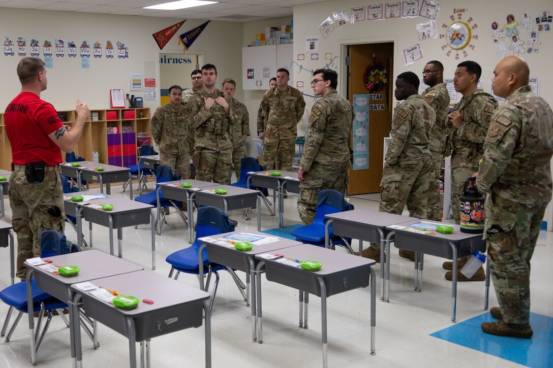 U.S. 316th Security Forces Group Airmen are briefed during a walkthrough of Imagine Andrews Public Charter School as part of active shooter training at Joint Base Andrews, Md., Nov. 7, 2023. The training gave the base's Defenders a better understanding of the school’s layout to increase readiness during an emergency. (U.S. Air Force photo by Airman 1st Class Gianluca Ciccopiedi)