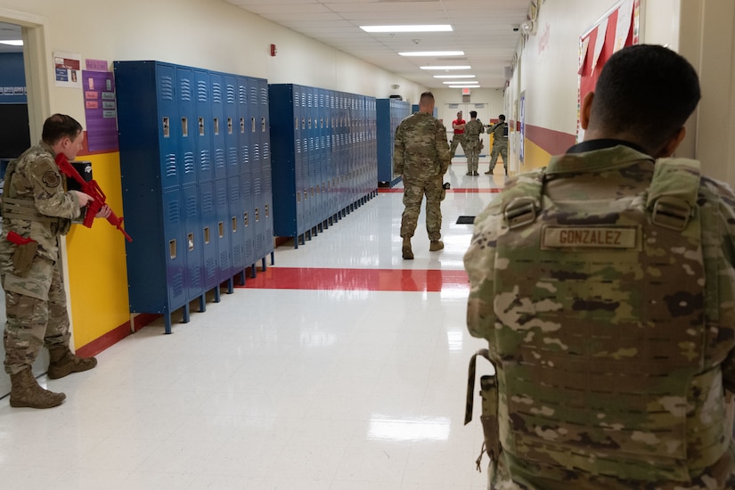 U.S. Airmen with the 316th Security Forces Squadron participate in active shooter training at Imagine Andrews Public Charter School at Joint Base Andrews, Md., Nov. 7, 2023. Training exercises such as these are one of the steps law enforcement at Andrews takes to ensure the safety and security of the community. (U.S. Air Force photo by Airman 1st Class Gianluca Ciccopiedi)