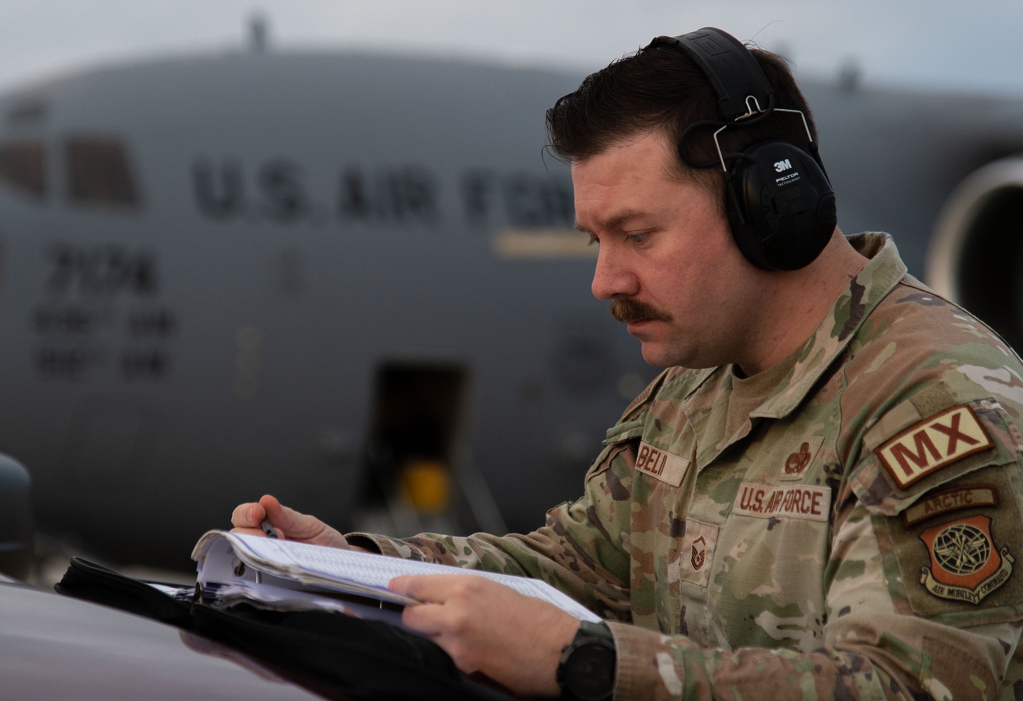 Master Sgt. Thomas Belin, 736th Aircraft Maintenance Squadron production superintendent, reviews the aircraft forms of a C-17 Globemaster III prior to its departure from Dover Air Force Base, Delaware, Nov. 15, 2023. Belin was named the winner of the 2023 Air Mobility Command Gen. Lew Allen Jr. Trophy. Named after the 10th Chief of Staff of the Air Force, the trophy is an AMC-level annual award that recognizes the accomplishments of officers and senior noncommissioned officers in the aircraft maintenance or munitions career fields, directly involved in sortie generation. (U.S. Air Force photo by Roland Balik)