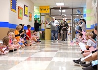 Soldier leading a parade through school.