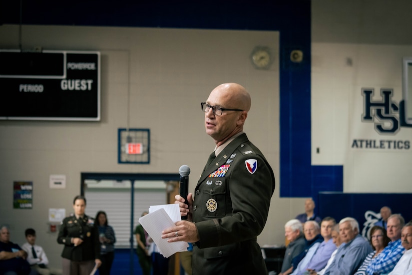 Soldier speaking to students.