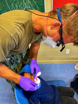 U.S. Navy Lt. Theodore Slagle, dentist, performs a routine dental exam on a young Ebeye student as part of Pacific Partnership, November 3. The dentists saw about 800 residents over the two-day event on Ebeye.