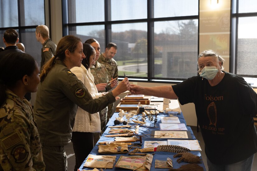 Kathy Miller, right, a retired Air Force senior noncommissioned officer and Native American history enthusiast, showcases Native American artifacts and recreated pieces during a Native American Heritage Month event at Joint Base Andrews, Md., Nov. 14, 2023. Miller shared facts and details about the artifacts with the event attendees. (U.S. Air Force photo by Airman 1st Class Gianluca Ciccopiedi)