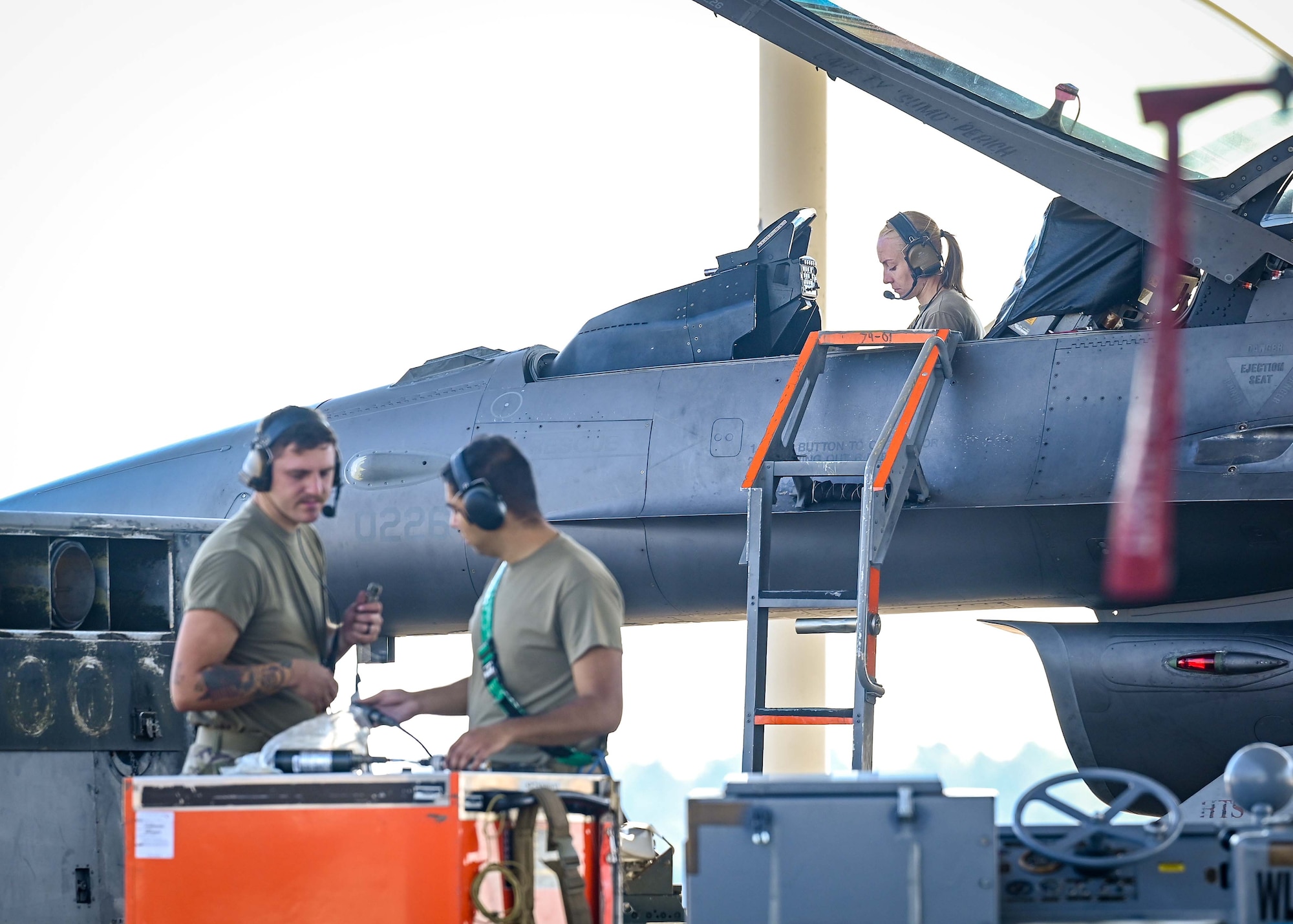 Airmen work together to ready an F-16 for flight.