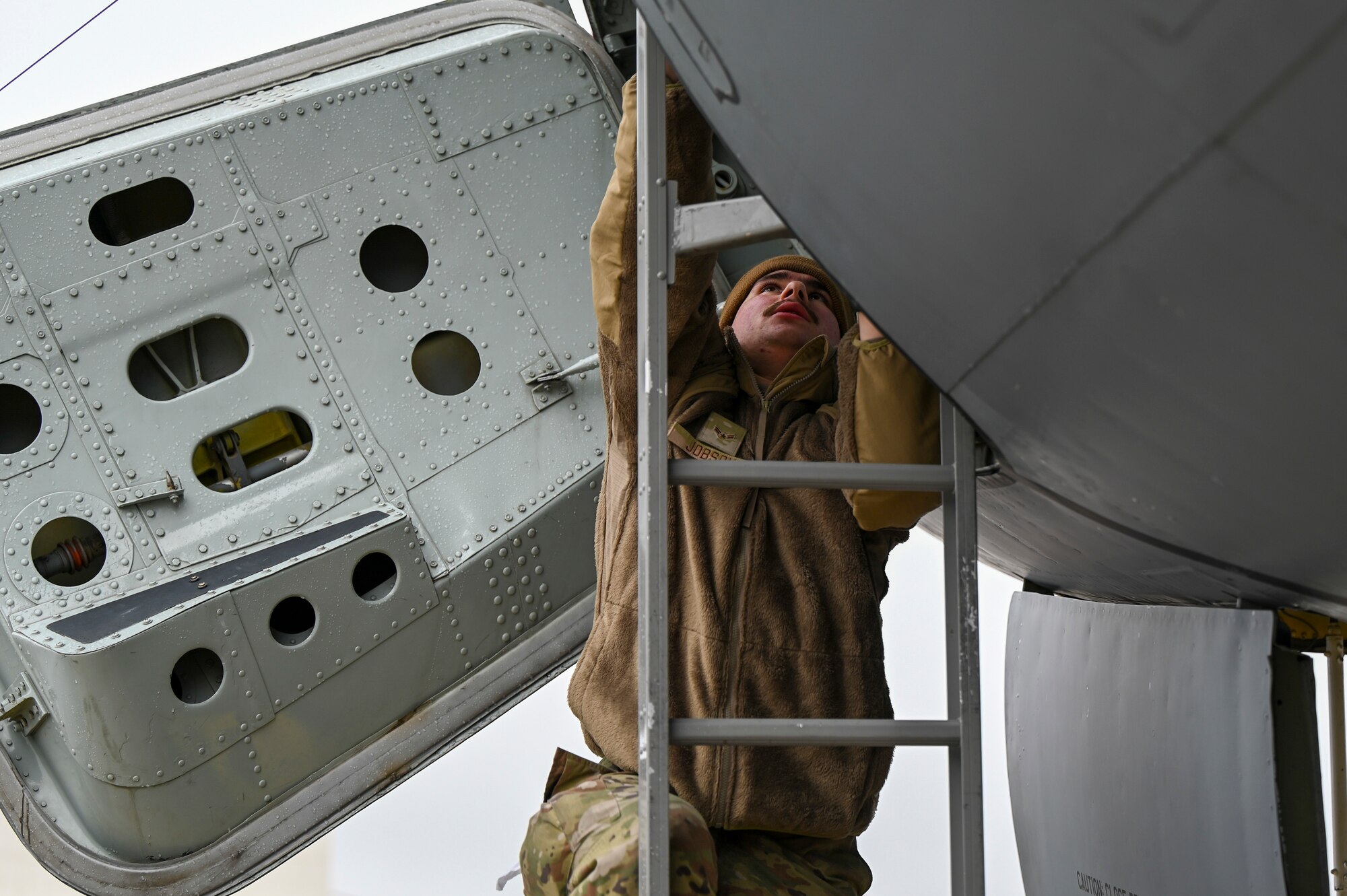 An Airman climbs up a KC-135