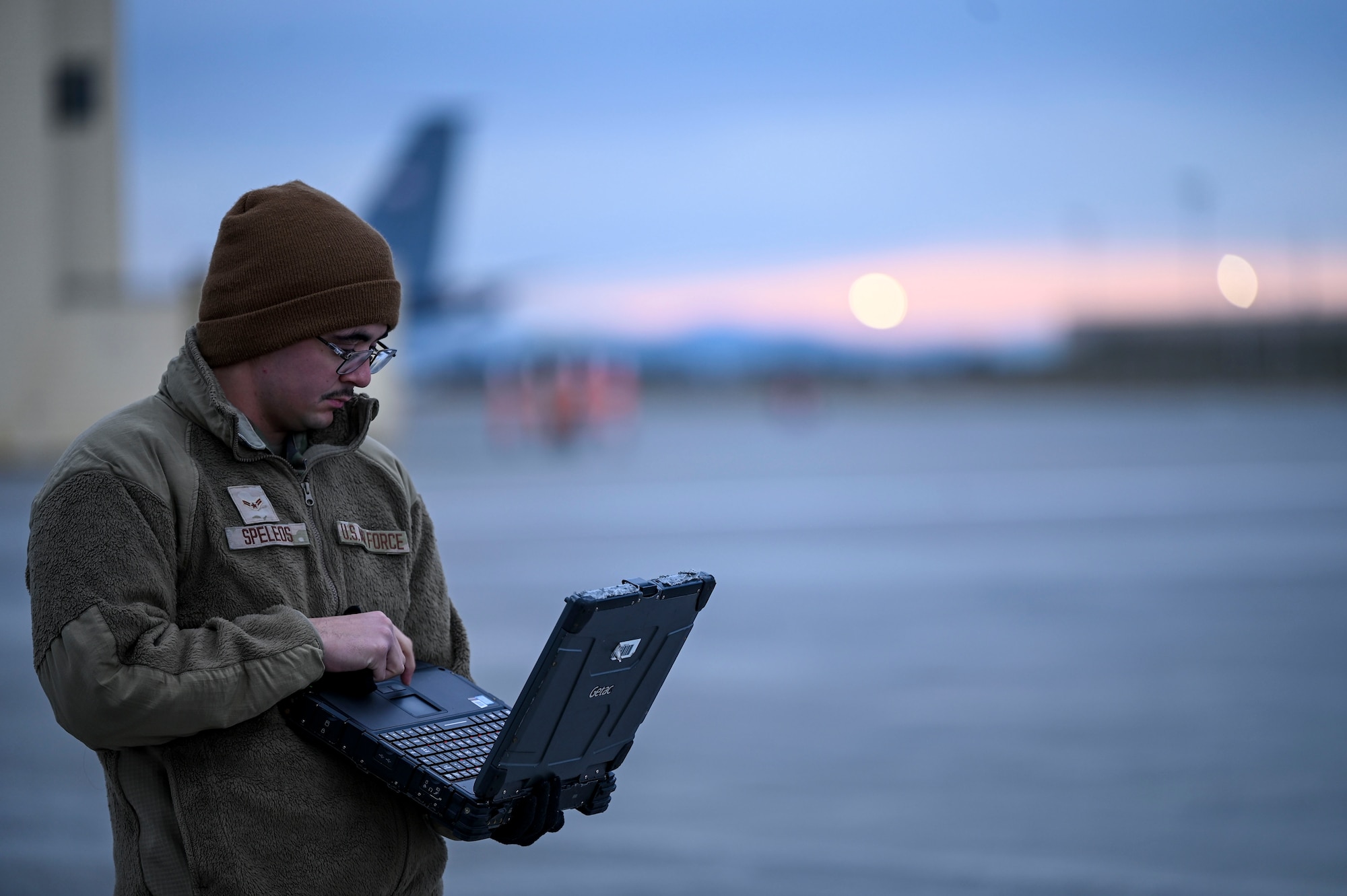 Airmen stands with computer